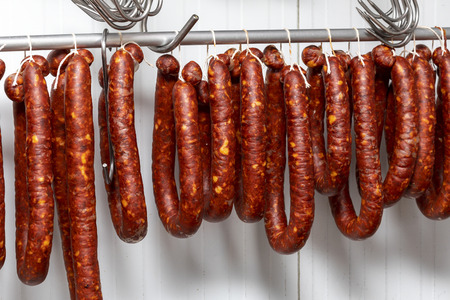 Chorizos cured and hung in strings (sausages)の写真素材