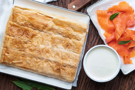 Salmon pie and fresh cheese (puff pastry). With natural ingredients. Home and rustic appearance.の写真素材