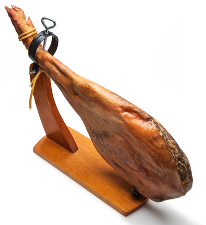 Whole leg of Spanish Iberian serrano ham in wooden support (jamoneror). Isolated on white...