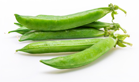 Green, tender, fresh and raw peas. Isolated on white background.の写真素材