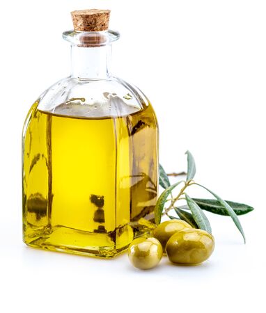Extra virgin olive oil in glass bottle. Foreground. Includes leaves and olive branches. Isolated on white background.の写真素材