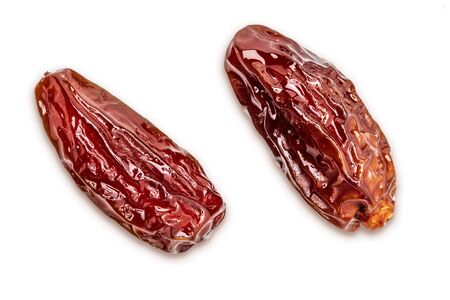 Close-up of juicy dates (fruit). Isolated on white background.