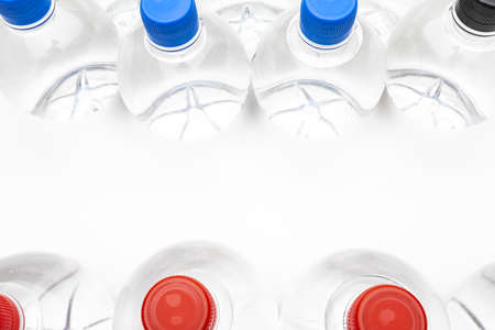 Background of transparent spherical water bottles with colored caps. With copy space.の写真素材