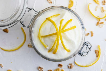Delicious yogurt dessert, with fresh lemon, without sugar and cereals. On white background.