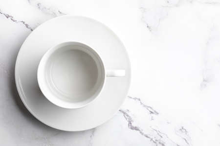 Empty white ceramic bowl on white marble background.の写真素材
