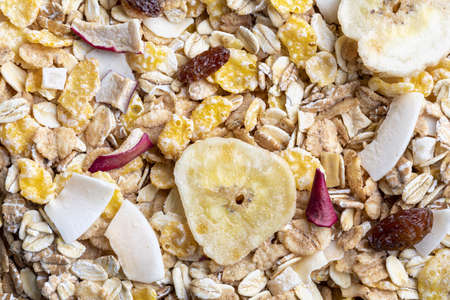 Texture with whole grains for breakfast. Macro close-up. Muesli with dried fruits and dried fruits....