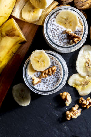 Appetizing, healthy and refreshing chia seed pudding with fresh blueberries and mint leaves. Vegetarian and vegan food with healthy superfoods. Homemade look. Top view with copy space.の写真素材