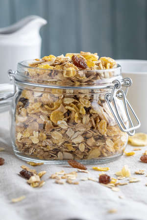 Glass jar with whole grains for breakfast. Muesli with dried fruits and dried fruits. With copy space.の写真素材