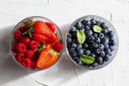 Appetizing variety of forest fruits (strawberries, large strawberries, raspberries, blueberries, red...