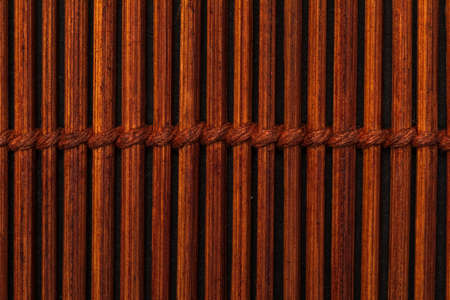 Dark reddish bamboo texture (collection of vegetal and natural fibers). Foreground.