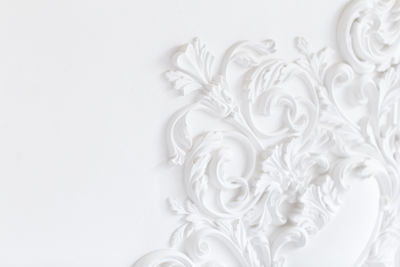 Beautiful ornate white decorative plaster moldings in studioの写真素材