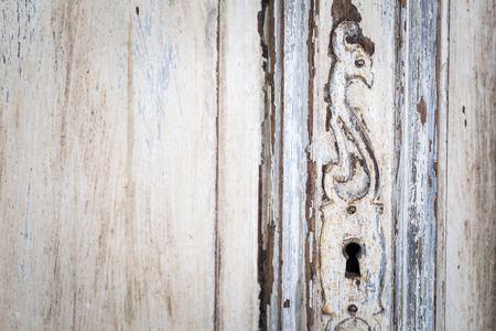 Vintage chest of drawers with carving white color with fading and metal handle. Close-up. Selective focusの写真素材