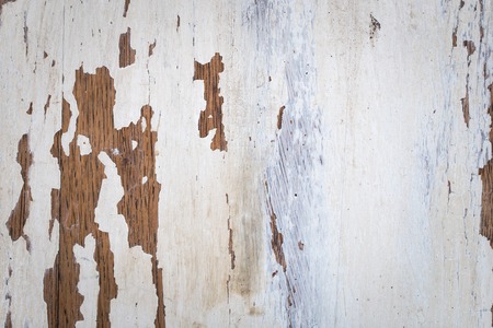Texture of a wooden surface with white cracked paint