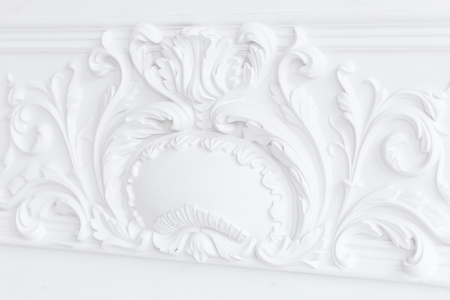 Beautiful ornate white decorative plaster moldings in studioの写真素材