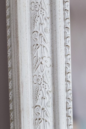Close-up of a vintage mirror with decorative ornamentsの写真素材