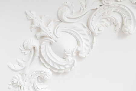 Beautiful ornate white decorative plaster moldings in studioの写真素材