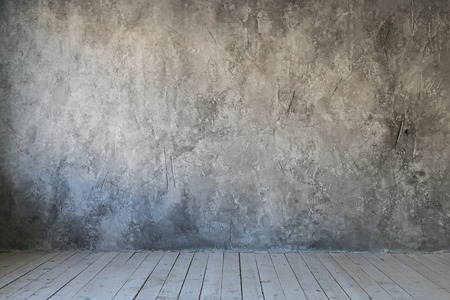 Gray textured wall of concrete and wood floor. Free space for textの写真素材