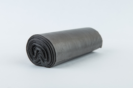 Black plastic polyethylene garbage bags roll isolated over the white background.の写真素材