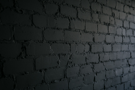 black brick wall background. texture dark masonryの写真素材