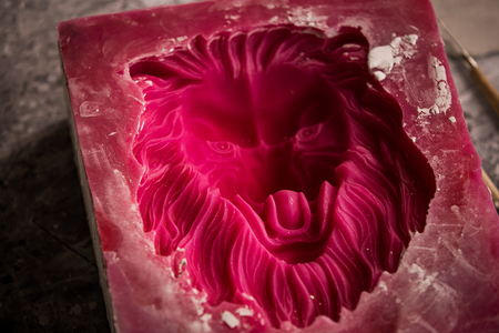Plaster workshop. Separates the silicone mold from the plaster sculpture of the lions head.の写真素材