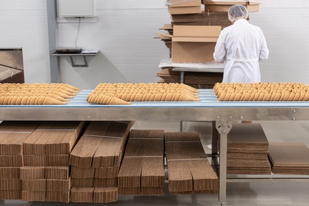 Ice cream production line. Conveyor production. Production of wafer cups for ice cream. Selective focusの写真素材