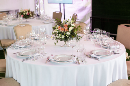 Serving a round table in the restaurant for several people. Selective focus.の写真素材