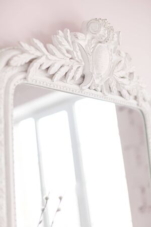 Vintage Baroque mirror with wood carvings in the Royal interior. Close up. Soft focus.の写真素材