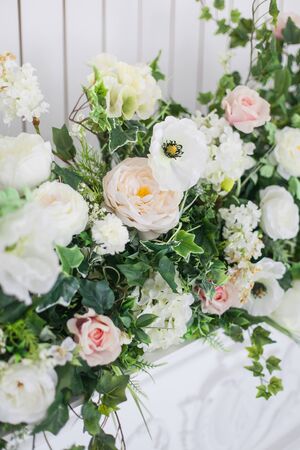 Decoration of the fireplace with flowers in a bright interior. close up. Soft focus.の写真素材