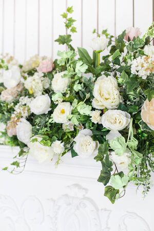 Decoration of the fireplace with flowers in a bright interior. close up. Soft focus.の写真素材