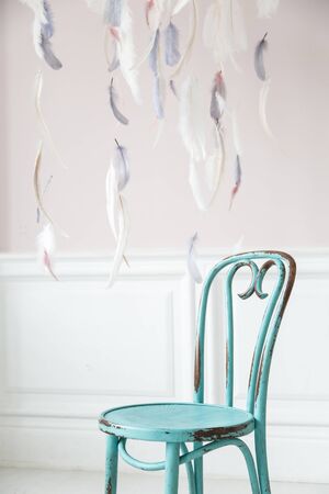 Vintage viennese chair against the wall with a bas-relief of plaster stucco. Selective focus.の写真素材