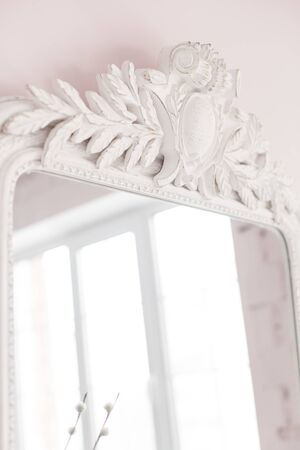 Vintage Baroque mirror with wood carvings in the Royal interior. Close up. Soft focus.の写真素材
