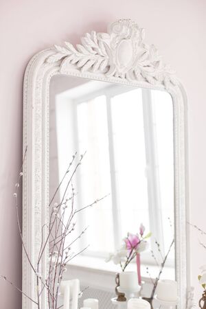 Vintage Baroque mirror with wood carvings in the Royal interior. Close up. Soft focus.の写真素材