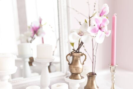 Delicate and light decoration of the dressing table with flowers, candles. Soft focus. Close up.の写真素材