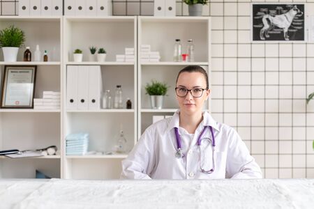 Portrait of a veterinarian in the office of the clinic for the clinic. Soft focus.の写真素材