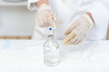 The doctor prepares a dropper with a solution of medicine. Close up.の写真素材