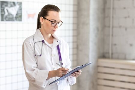 A young doctor, a veterinarian at the clinic.の写真素材