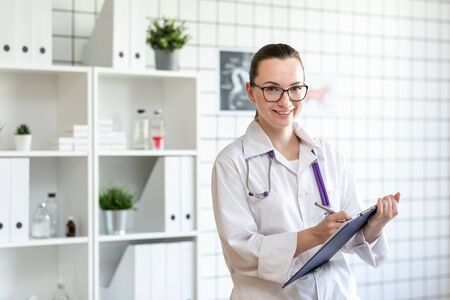 Portrait of a veterinarian doctor with a smile. Blurred background of veterinary clinic.の写真素材