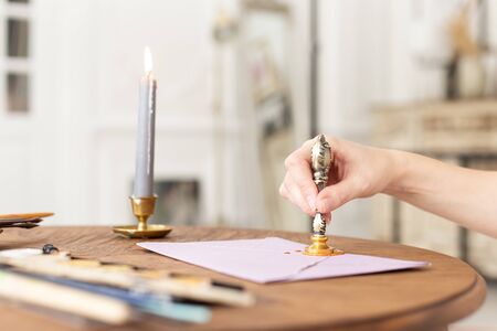 Stamping old notarial wax seal on document. Close up. Selective focus.の写真素材
