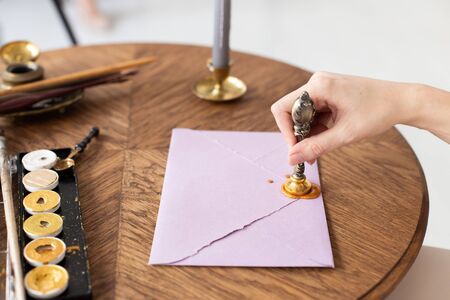 Stamping old notarial wax seal on document. Close up. Selective focus.の写真素材
