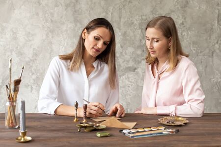 Learning calligraphy in art workshop. Teacher and students. Art school handwriting.の写真素材
