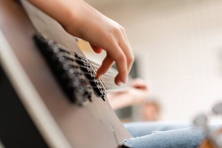 Young male hands playing electric guitar. Concept of learning to play a musical instrumentの写真素材