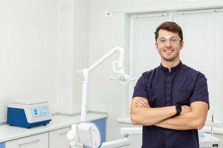 Dental polymerization lamp with UV light and laser. Stomatological instrument in the dentist clinic. Medicine, health, stomatology concept.の写真素材