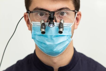 Dental polymerization lamp with UV light and laser. Stomatological instrument in the dentist clinic. Medicine, health, stomatology concept.の写真素材