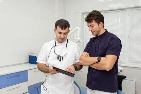 Two hospital workers examinig resoults of patients analyses togetherの写真素材