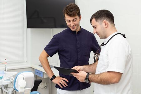 Two dentists discuss diagnosis of their clientの写真素材