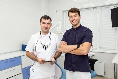 Two men in doctor uniform posing for a cameraの写真素材