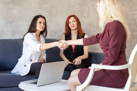 The new worker and the boss perpetuate the agreement with a handshake. Selective focusの写真素材