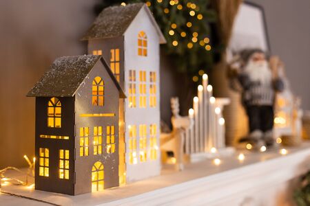 Closeup of paper houses with lights inside standing on background of other decorations. Selective focusの写真素材