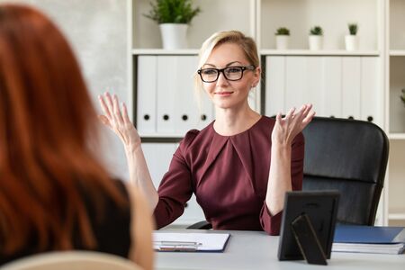The pretty Manager tells the new candidate about her duties at job interview. Selective focusの写真素材
