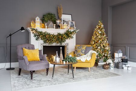 Nizhniy Novgorod, Russia - November 8, 2019: Photo studio 2.8. Living room decorated for Christmass with Christmass standing near fireplaceのeditorial素材